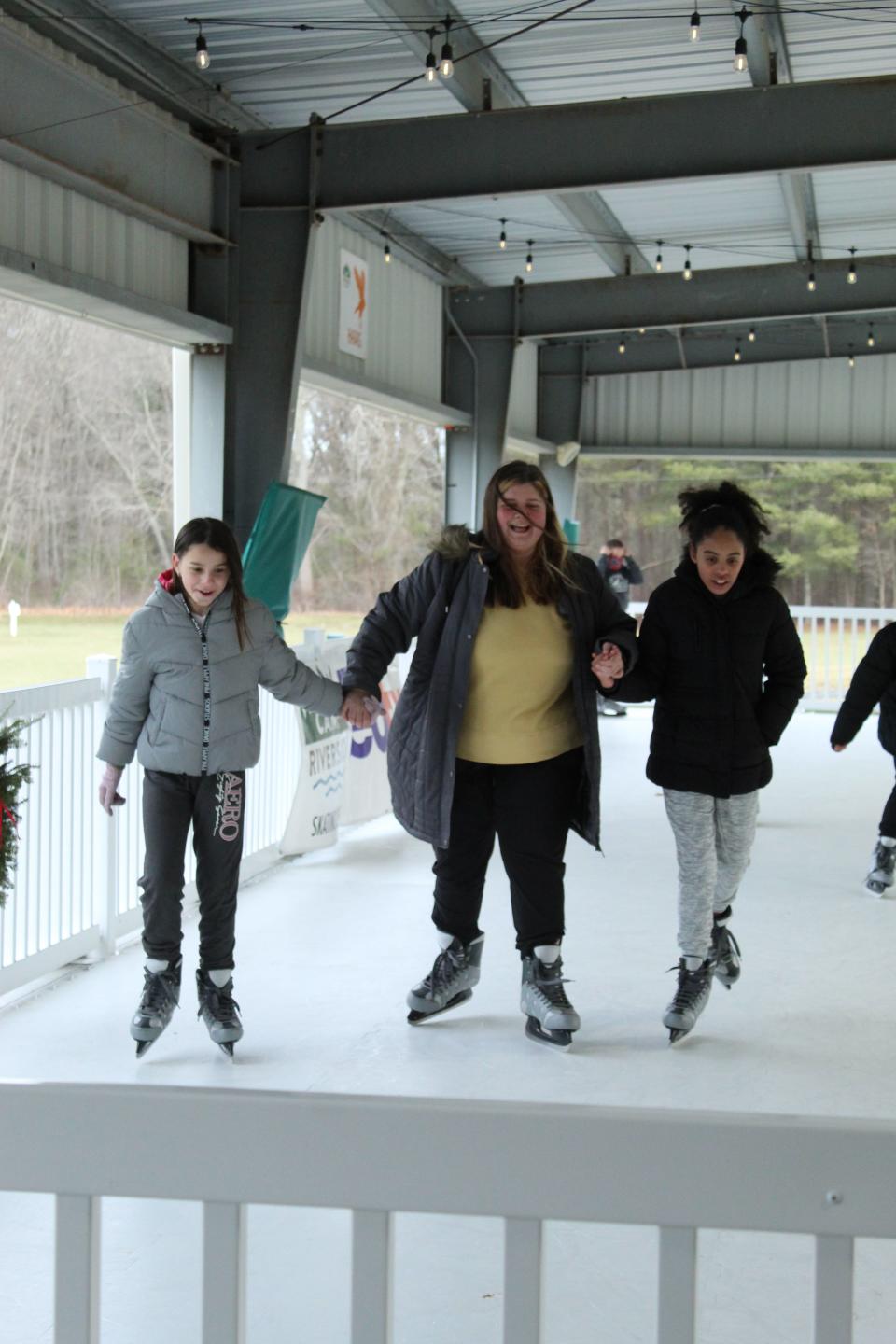 Boys & Girls Clubs of Metro South members and staff skate together at the synthetic ice rink at Camp Riverside in Taunton.