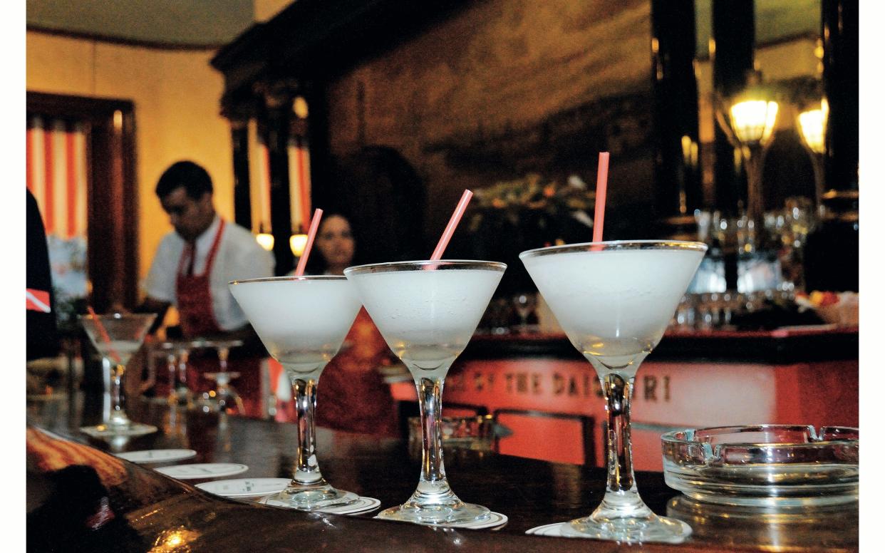 Barman mixing drinks in Cuba - Credit: Wolfi Poelzer / Alamy Stock Photo