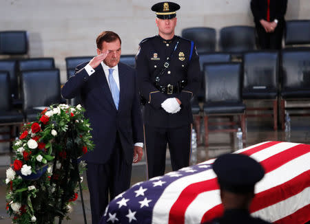 Governor Tom Ridge salutes the casket of the late U.S. Senator John McCain as his body lies in state inside the U.S. Capitol Rotunda in Washington, U.S., August 31, 2018. REUTERS/Eric Thayer