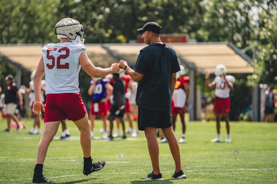 Iowa State coach Matt Campbell and defensive end Joey Petersen greet one another during a recent practice.