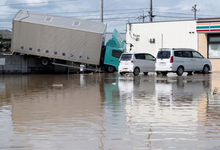 A truck which was stranded by flood is seen in a flooded area in Mabi town in Kurashiki, Okayama Prefecture, Japan, July 8, 2018. REUTERS/Issei Kato