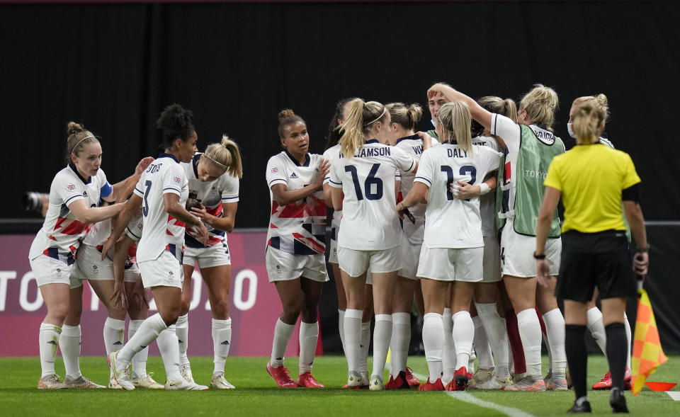 Britain players celebrate after Ellen White scores her opening goal during a women's soccer match against Japan at the 2020 Summer Olympics, Saturday, July 24, 2021, in Sapporo, Japan. (AP Photo/Silvia Izquierdo)