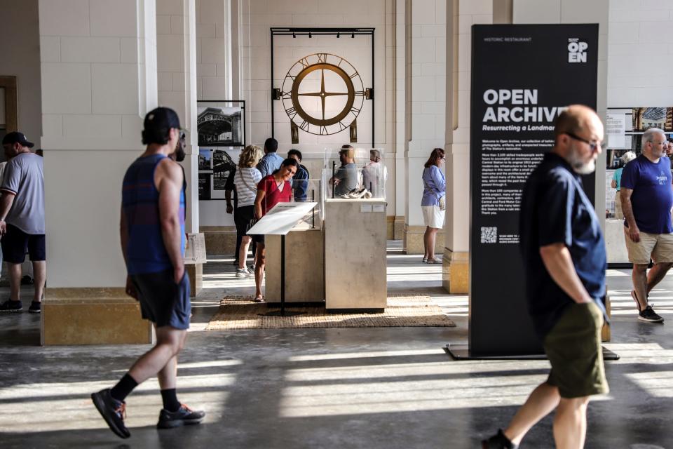 The Original Carriage House Clock hangs in the back of the room while people tour the first floor of the Michigan Central Station for the “Summer at the Station” on Friday, June 21, 2024 in Detroit.