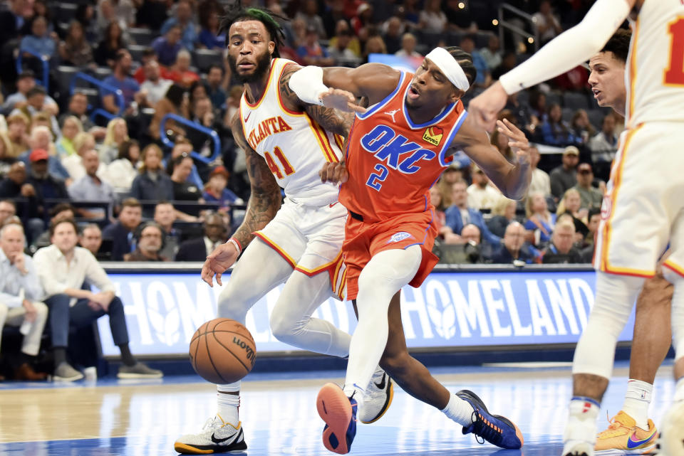 Oklahoma City Thunder guard Shai Gilgeous-Alexander (2) loses the ball as he tries to push past Atlanta Hawks forward Saddiq Bey (41) in the second half of an NBA basketball game, Monday, Nov. 6, 2023, in Oklahoma City. (AP Photo/Kyle Phillips)