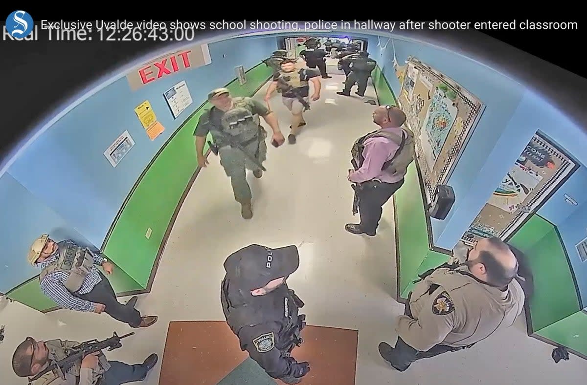 Video from the Uvalde, Texas shooting showed armed police officers waiting outside classrooms for over an hour while the shooter continued his massacre  (ASSOCIATED PRESS)