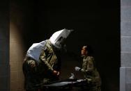 U.S. Army soldiers test the fit of N95 masks at a military field hospital for non-coronavirus patients inside CenturyLink Field Event Center during the coronavirus disease (COVID-19) outbreak in Seattle