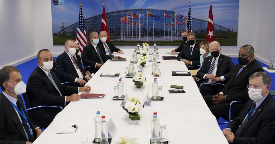 President Joe Biden, center right, and Turkish President Recep Tayyip Erdogan, center left, visit during a bilateral meeting while attending the NATO summit at NATO headquarters in Brussels, Monday, June 14, 2021. (AP Photo/Patrick Semansky)