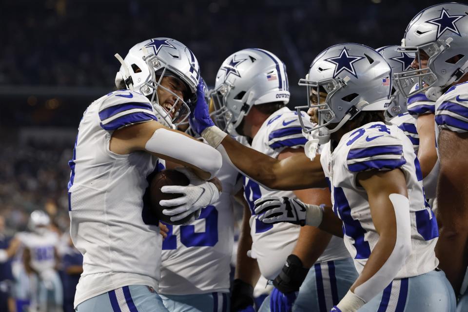 Dallas Cowboys wide receiver Simi Fehoko (81), running back Malik Davis (34) and others celebrate after Fehoko caught a touchdown pass in the first half of a preseason NFL football game against the Seattle Seahawks in Arlington, Texas, Friday, Aug. 26, 2022. (AP Photo/Ron Jenkins)