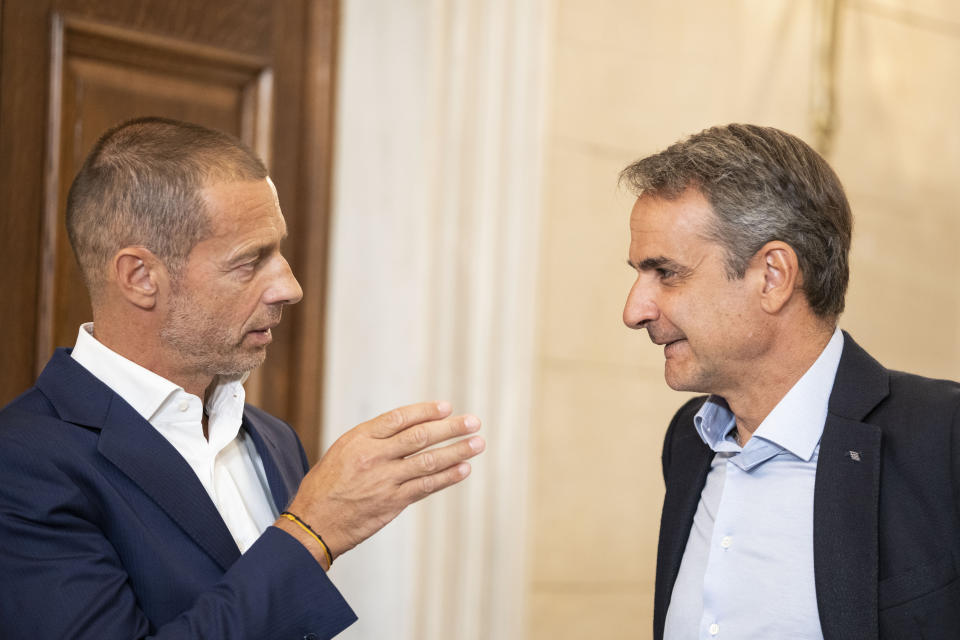 Greek Prime Minister Kyriakos Mitsotakis, right, speaks with UEFA President Aleksander Ceferin after their meeting in Athens, Wednesday, Aug. 16, 2023, in the wake of a deadly attack led by Croatian football supporters in the Greek capital. The meetings, joined by representatives from Greece's four major clubs, were held hours before Greece hosts the annual UEFA Super Cup between Sevilla and Manchester City. (AP Photo/Petros Giannakouris)