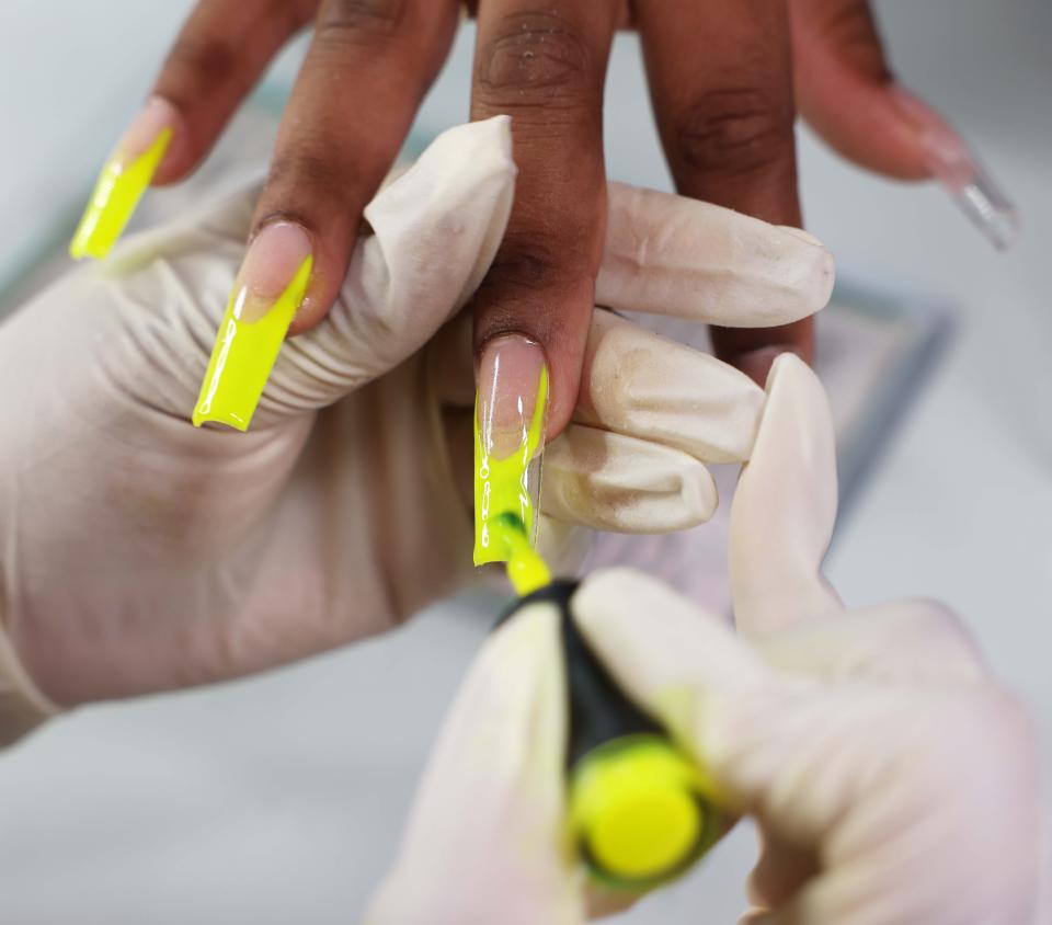 Verdia Joslyn owner of Kiss Her Boutique, 22 North St., Randolph, works on client Chelsie Gilfillan's nails on Saturday, Aug. 13, 2022.