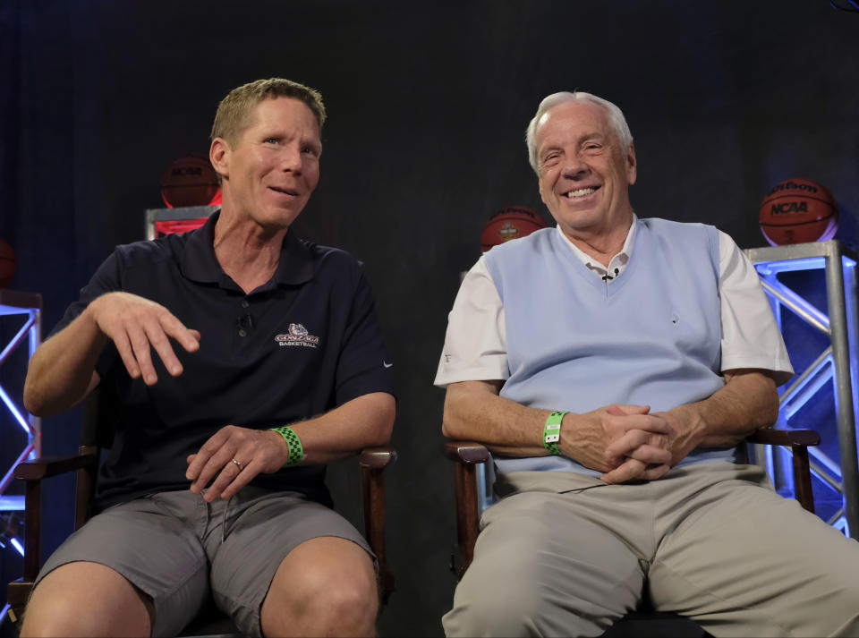 FILE - Gonzaga head coach Mark Few, left, talks to North Carolina head coach Roy Williams during a CBS Sports Network interview for the Final Four NCAA college basketball tournament, Sunday, April 2, 2017, in Glendale, Ariz. (AP Photo/David J. Phillip, File)