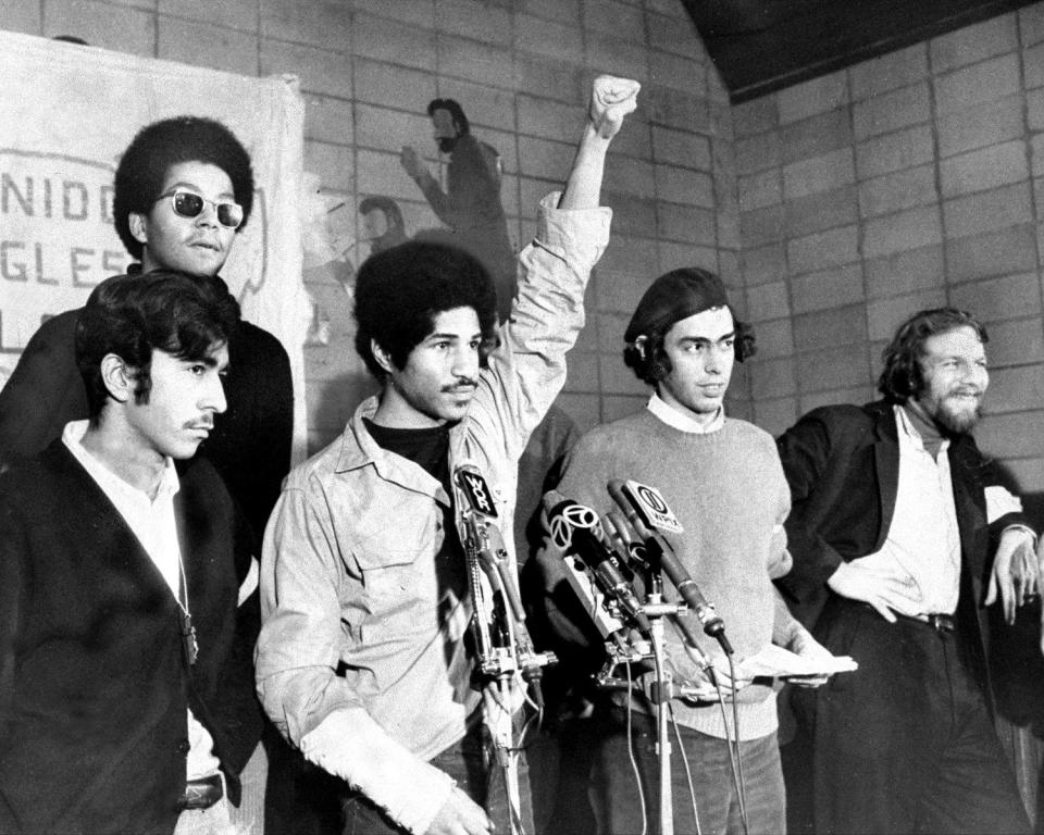 Pablo Guzmán, information minister, rear wearing sunglasses, at a Young Lords news conference with Juan González, education minister, at right. (Anthony Pescatore / NY Daily News Archive via Getty Images)