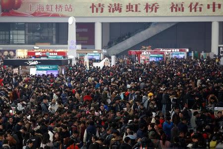 Passengers wait to board trains at Shanghai's Hongqiao Railway Station as hundreds of millions of Chinese travel home for Lunar New Year in Beijing and Shanghai, in Shanghai, China January 25, 2017. REUTERS/Aly Song