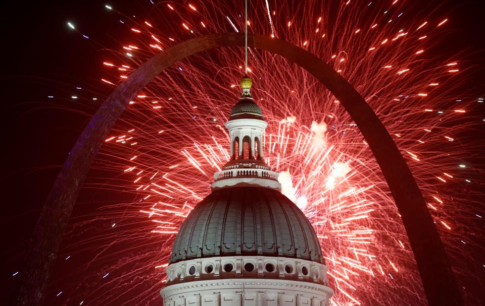 Fireworks light up the night sky over the Gateway Arch and Old Courthouse as part of an Independence Day celebration onJuly 4, 2019, in St. Louis.