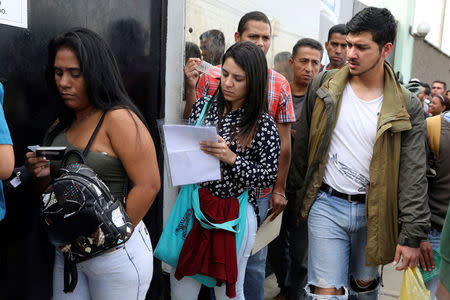Venezuelan citizens queue to regularize their immigration papers at the Interpol office in Lima, Peru, May 10, 2018. REUTERS/Guadalupe Pardo