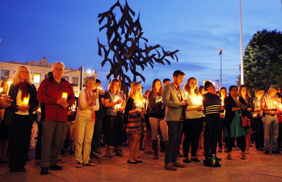 Boston University students and faculty members hold a candlelight vigil on Marsh Plaza at Boston University, Saturday, May 12, 2012, for three students studying in New Zealand who were killed when their minivan crashed during a weekend trip. At least five other students were injured in the accident, including one who was in critical condition. Boston University spokesman Colin Riley said those killed in the accident were Daniela Lekhno, 20, of Manalapan, N.J.; Austin Brashears, 21, of Huntington Beach, Calif.; and Roch Jauberty, 21, whose parents live in Paris. (AP Photo/Bizuayehu Tesfaye)