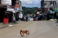 Policemen stand guard along the main road of Marawi City, as government forces continue their assault against insurgents from the Maute group, who have taken over large parts of Marawi City, Philippines June 22, 2017. REUTERS/Romeo Ranoco