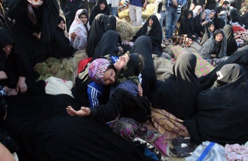 Iranians mourn for their loved ones in the village Baje-Baj, near the town of Varzaqan. Iran on Sunday stepped up relief operations in shattered villages in its northeast after saying rescue operations were completed following a double earthquake which cost 227 lives and injured 1,380 people