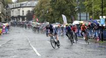 Cyclists ride under pouring rain during the men elite race, at the road cycling World Championships in Harrogate, England, Sunday, Sept. 29, 2019. (AP Photo/Manu Fernandez)