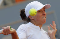 Poland's Iga Swiatek plays a shot against Sofia Kenin of the U.S. in the final match of the French Open tennis tournament at the Roland Garros stadium in Paris, France, Saturday, Oct. 10, 2020. (AP Photo/Michel Euler)