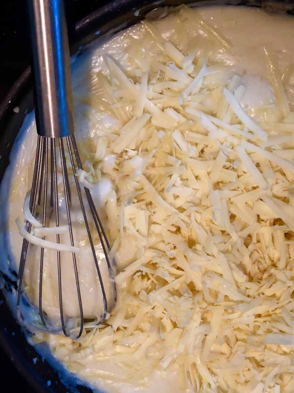 Stirring a homemade cheese sauce.
