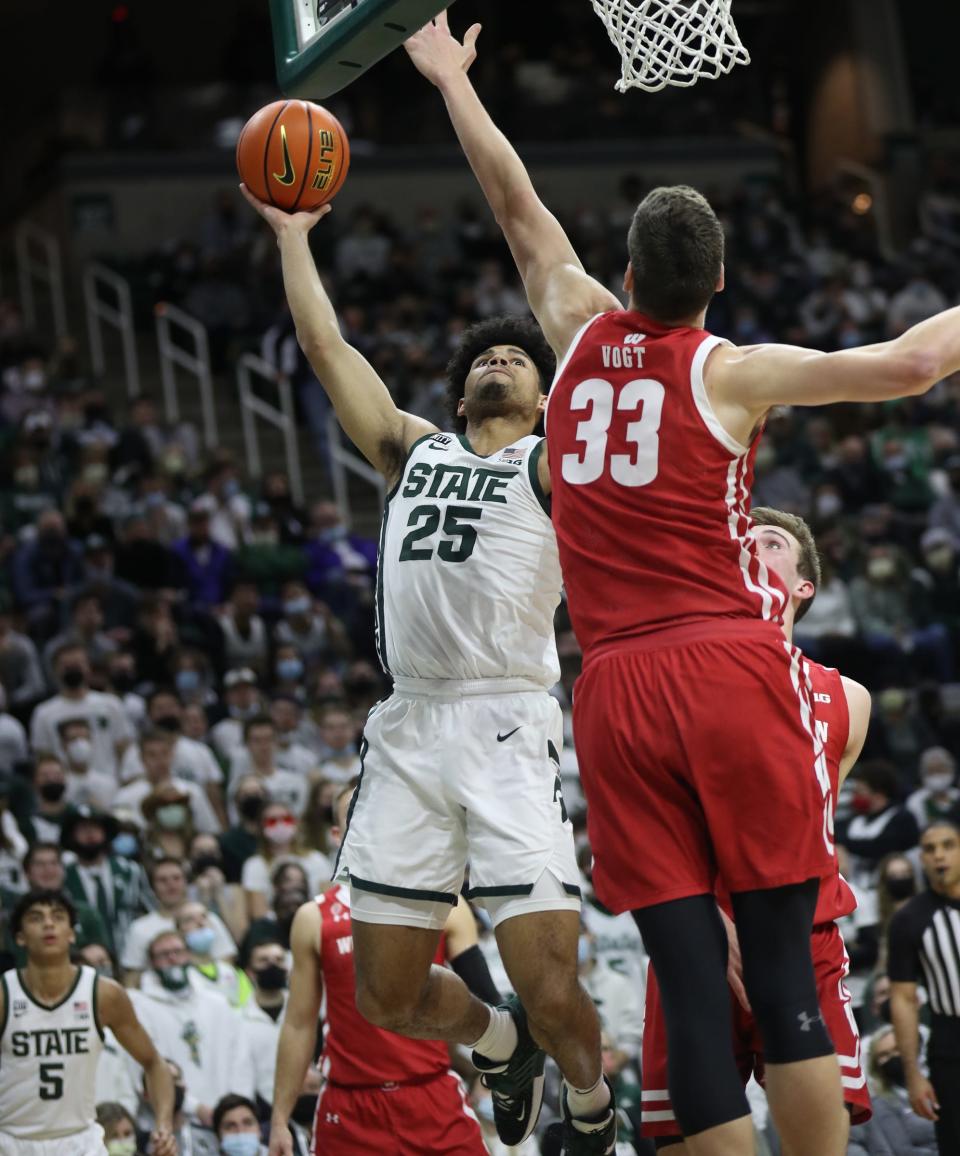 Michigan State forward Malik Hall shoots against Wisconsin center Chris Vogt during the first half on Tuesday, Feb. 8, 2022, at the Breslin Center.