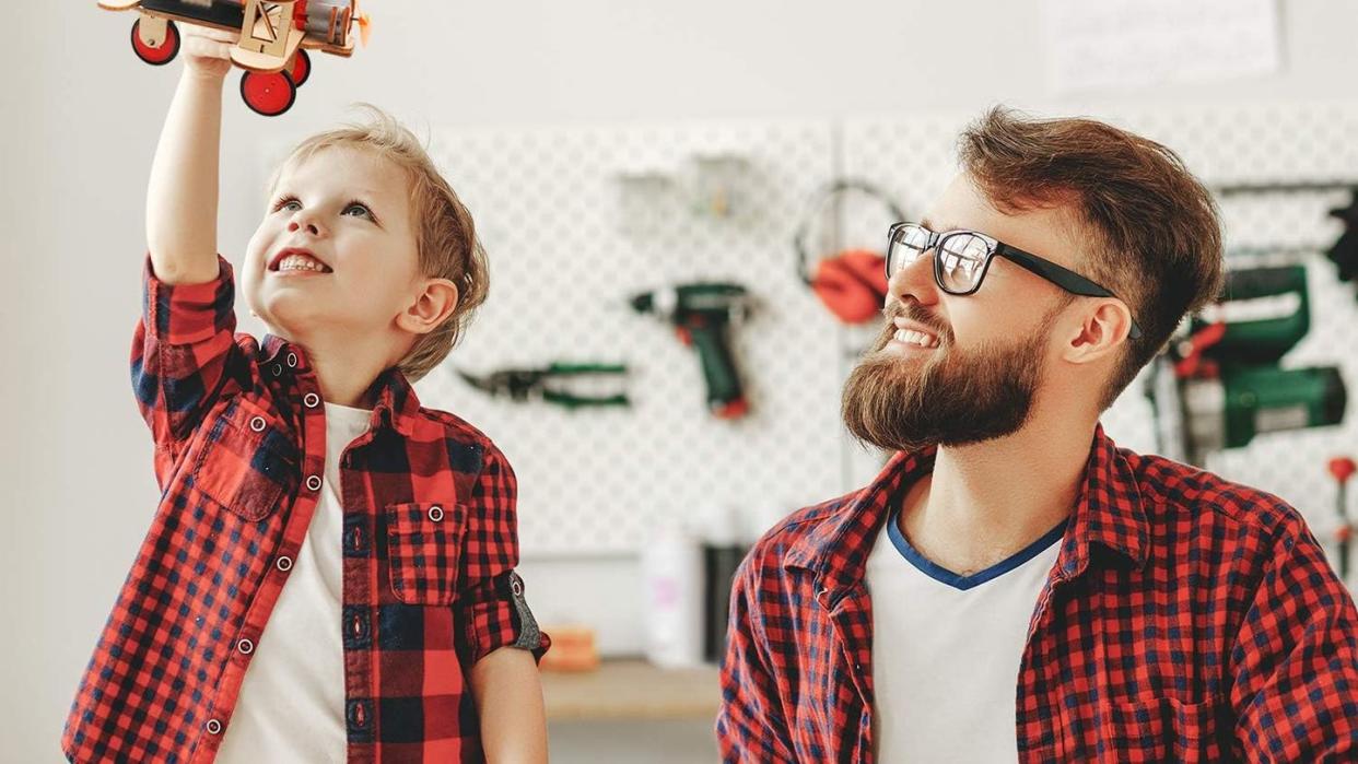 a man and a boy playing with toys