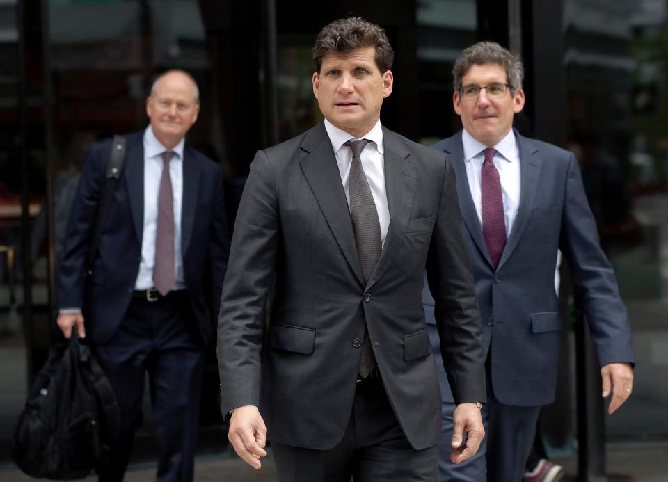 Gordon Caplan departs federal court, Thursday, Oct. 3, 2019, in Boston, after being sentenced in a nationwide college admissions bribery scandal. Caplan was sentenced to one month in prison for paying $75,000 to rig his daughter’s ACT exam.