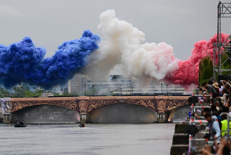 Pyrotechnics in the colors of the French national flag are launched over a bridge during the opening ceremonies of the Paris Olympics on July 26, 2024. / Credit: Sina Schuldt/picture Alliance via Getty Images