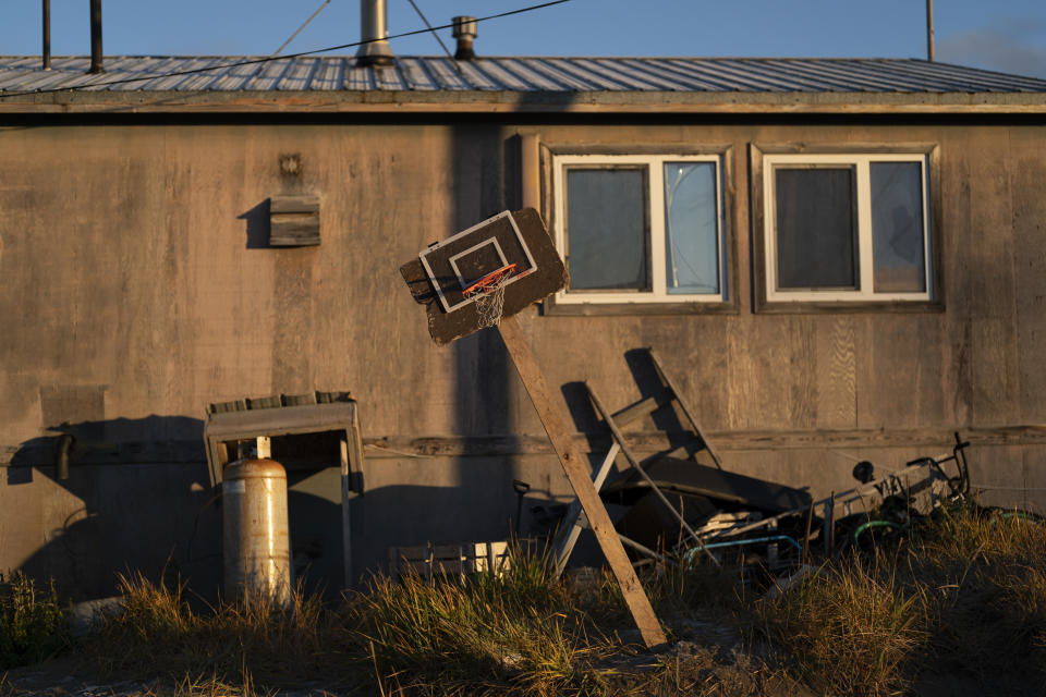 A homemade basketball hoop stands tilted outside a home in Shishmaref, Alaska, Saturday, Oct. 1, 2022. (AP Photo/Jae C. Hong)