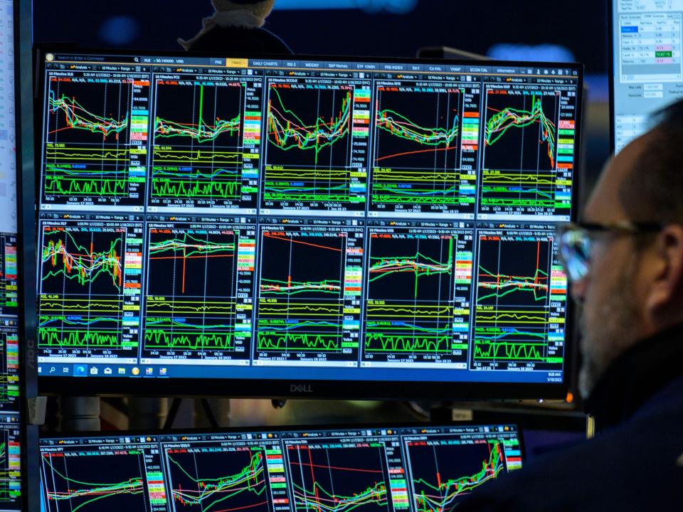 A trader looks at market charts on the floor of the New York Stock Exchange.