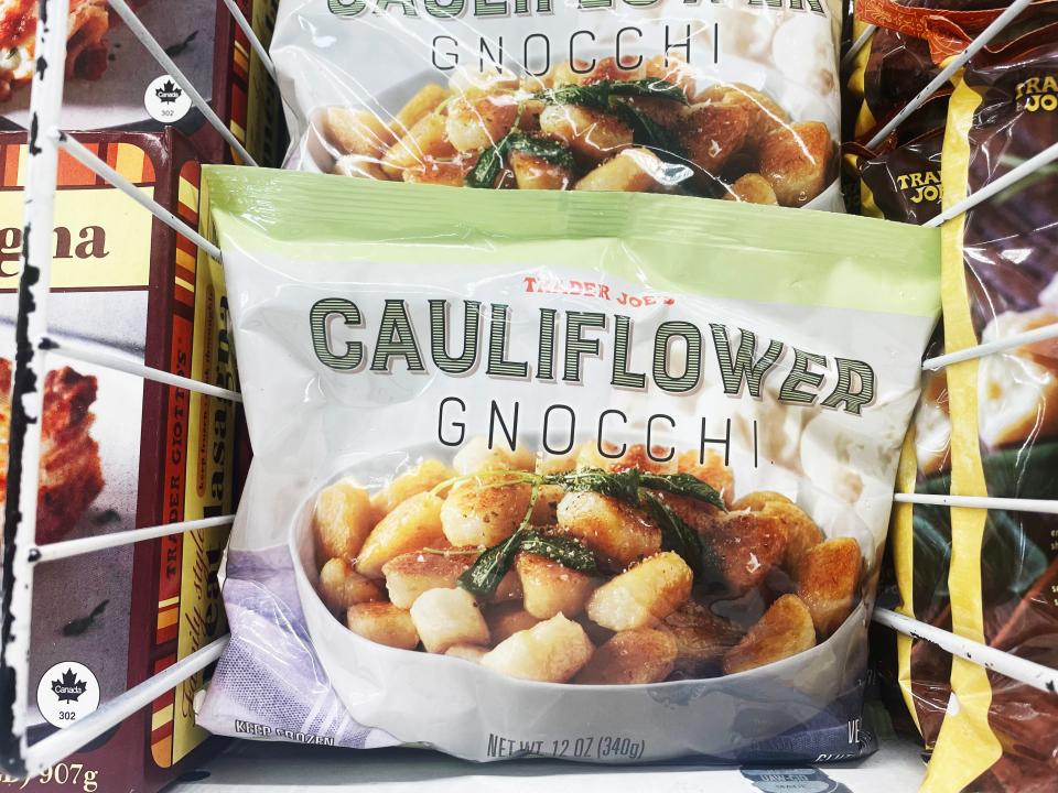 White and green bag with images of gnocchi in freezer section of Trader Joe's