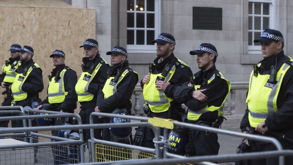 Police officers stand guard as Palestinian supporters gather outside Israel's embassy in London on October 9.  - Wiktor Szymanowicz/Future Publishing/Getty Images