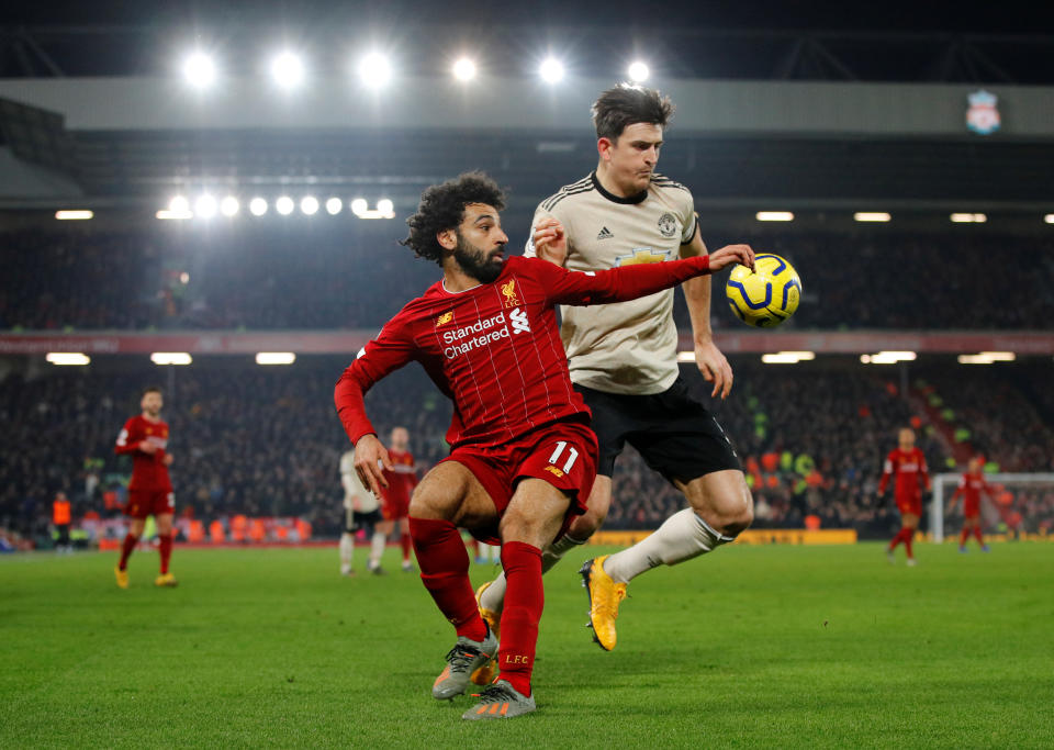 Liverpool's Mohamed Salah (front) in action with Manchester United's Harry Maguire. 