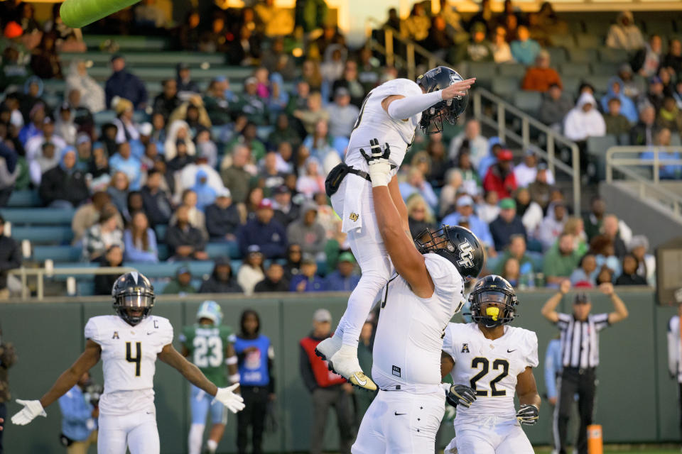 UCF quarterback John Rhys Plumlee, center, celebrates a touchdown against Tulane in the second half of an NCAA college football game in New Orleans, Saturday, Nov. 12, 2022. (AP Photo/Matthew Hinton)