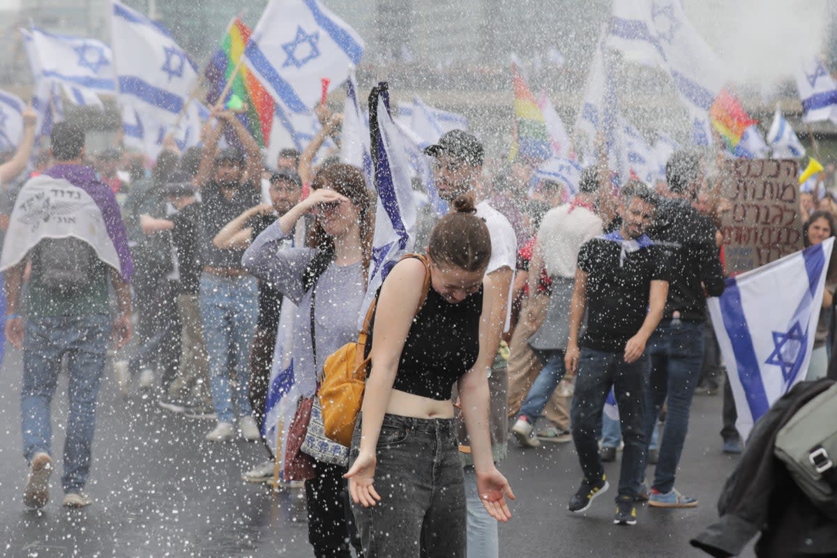 Police use water cannons on protesters blocking the Ayalon Highway in Tel Aviv on Thursday (EPA)