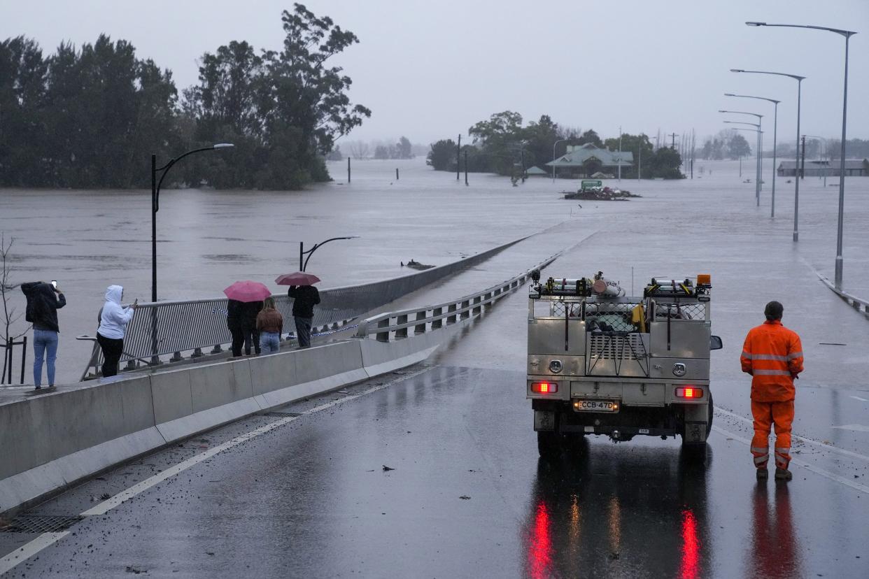 An emergency vehicle blocks access to the flooded Windsor Bridge on the outskirts of Sydney, Australia, Monday, July 4, 2022.