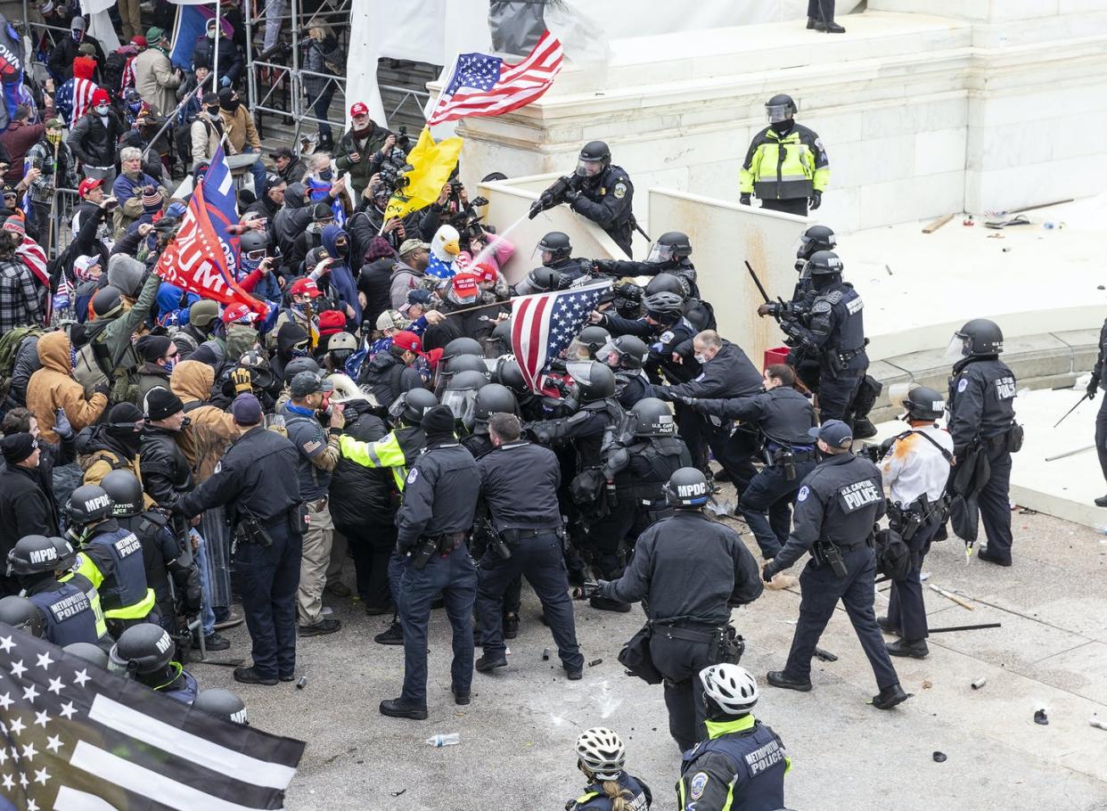 Pro-Trump protesters and police clash on Jan. 6, 2021, at the U.S. Capitol. <a href="https://www.gettyimages.com/detail/news-photo/pro-trump-protesters-and-police-clash-on-top-of-the-capitol-news-photo/1230465345?adppopup=true" rel="nofollow noopener" target="_blank" data-ylk="slk:Lev Radin/Pacific Press/LightRocket via Getty Images);elm:context_link;itc:0;sec:content-canvas" class="link "> Lev Radin/Pacific Press/LightRocket via Getty Images)</a>