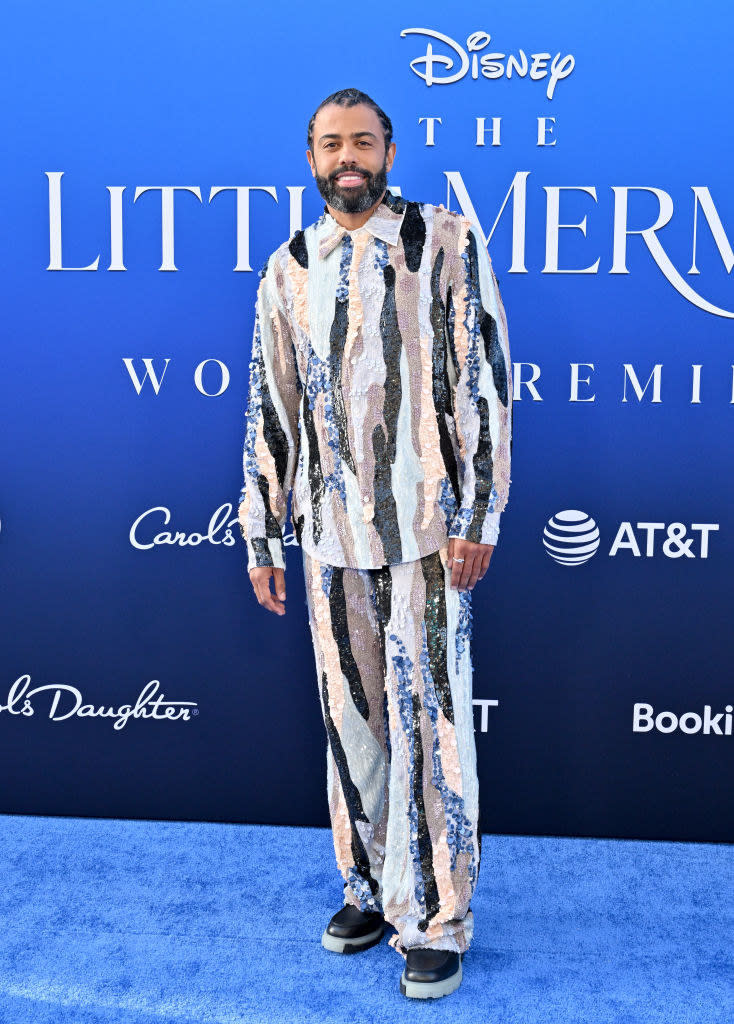 Daveed Diggs at "The Little Mermaid" premiere wearing a multicolored sequined dress shirt and matching pants