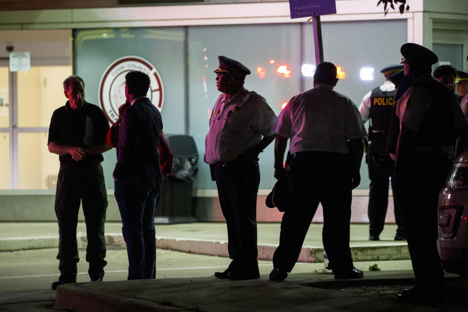 Police gather outside Stroger Hospital where two officers were brought after being shot while dispersing a crowd on the 100 block of North Long Avenue during the Fourth of July holiday weekend in the early hours of Monday, July 5, 2021, in Chicago. (Armando L. Sanchez/Chicago Tribune via AP)