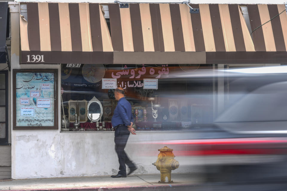 An Iranian business owner strolls outside his business in the so-called "Tehrangeles" neighborhood in the Westwood district of Los Angeles on Monday, May 20, 2024. (AP Photo/Damian Dovarganes)