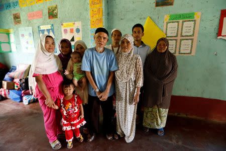 Edris Candidato and his family pose for a picture inside a classroom in a madrasa used as an evacuation center outside Marawi, while government forces still fight insurgents from the Maute group in Marawi City, Philippines June 26, 2017. REUTERS/Jorge Silva