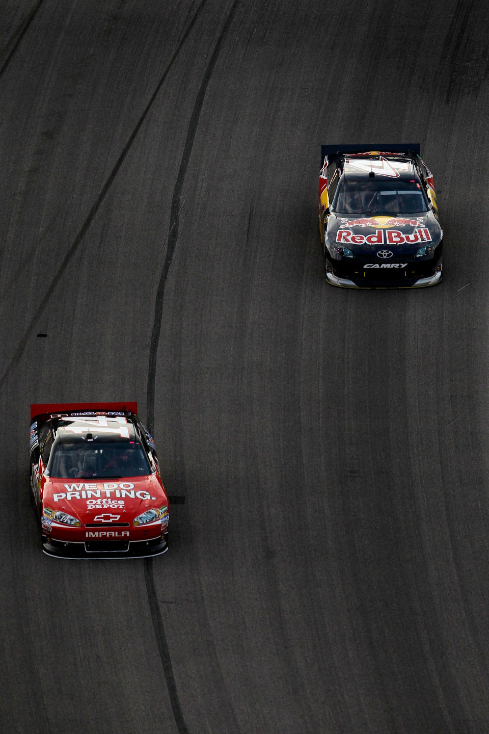 FORT WORTH, TX - NOVEMBER 06: Tony Stewart, driver of the #14 Office Depot/Mobil 1 Chevrolet, leads Kasey Kahne, driver of the #4 Red Bull Toyota, during the NASCAR Sprint Cup Series AAA Texas 500 at Texas Motor Speedway on November 6, 2011 in Fort Worth, Texas. (Photo by Tom Pennington/Getty Images for NASCAR)