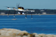 A drone, made by CyPhy Works, carries a UPS package on Children's Island off the coast of Beverly, Massachusetts during UPS's demonstration of a drone making a commercial delivery of a package to a remote or difficult-to-access location. REUTERS/Brian Snyder