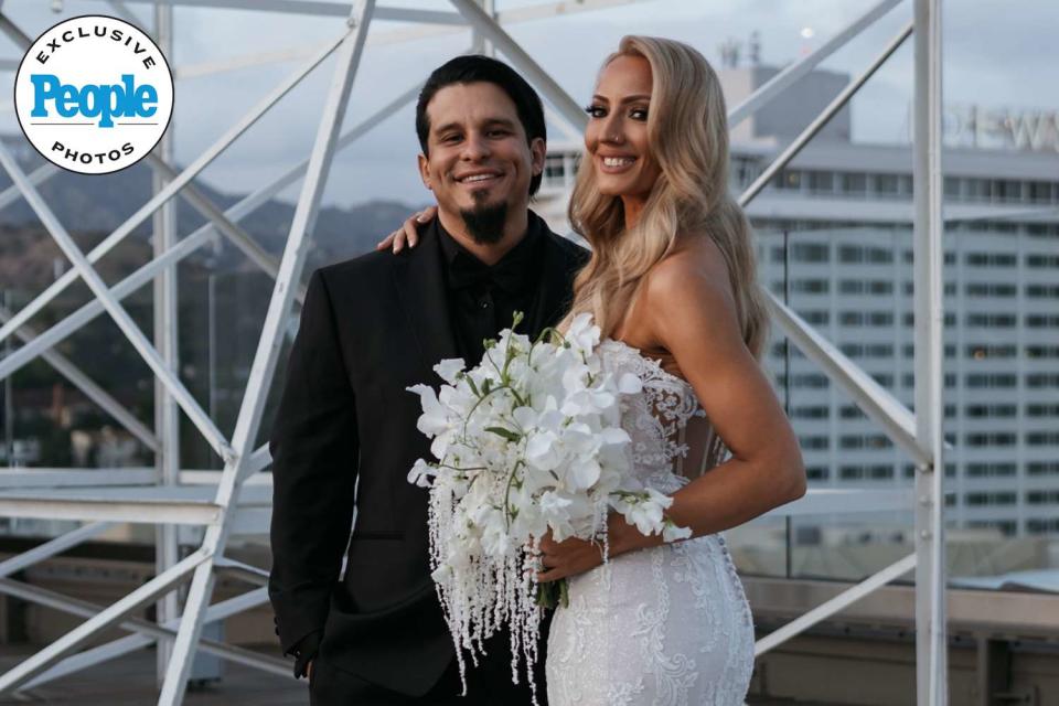 <p>DeAngelo Castro for SYMBOLL</p> Nita Strauss and Josh Villalta pose at their May 4 wedding