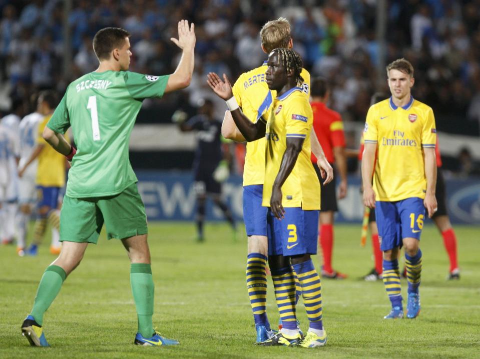 Arsenal's Wojciech Szczesny and Bacary Sagna (R) celebrate after their team won their Group F Champions League soccer match against Olympique Marseille at the Velodrome stadium in Marseille, September 18, 2013. REUTERS/Philippe Laurenson (FRANCE - Tags: SPORT SOCCER)