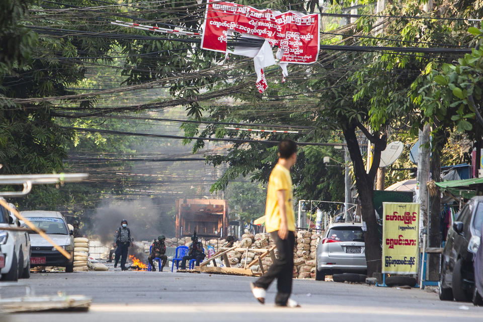 Police and military forces occupy a road block barricade in Yangon, Myanmar, Friday, March 19, 2021. The authorities in Myanmar have arrested a spokesman for ousted leader Aung San Suu Kyi's political party as efforts to restrict information about protests against last month's military takeover are tightened. (AP Photos)