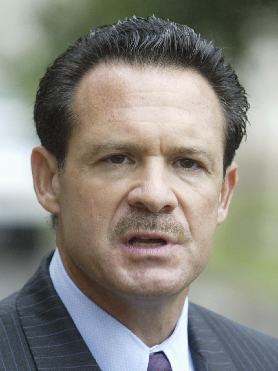 FILE In this Aug. 24, 2004 file photo, attorney Paul W. Bergrin speaks to the media in front of the U.S. military court at Taylor Barracks in Mannheim, southern Germany. In Newark, N.J., on Monday, March 18, 2013, the once-prominent New Jersey defense attorney whose clients included entertainers and rap stars was found guilty on all counts at his murder and racketeering trial. Jurors deliberated for a full day and parts of two others before returning their verdict in the case of Paul Bergrin. He faced numerous counts including murder, racketeering, conspiracy, prostitution and drug-related offenses. (AP Photo/Michael Probst, File)