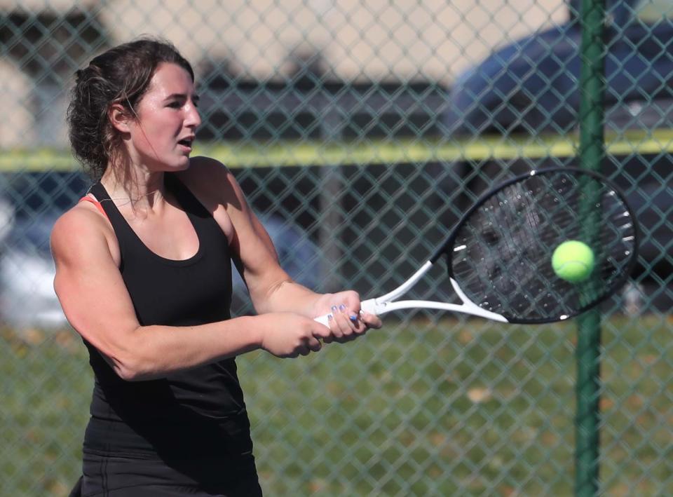 Tess Bucher of North Canton Hoover returns the ball for the point as she plays in the championship match in the Division I district girls tennis tournament at Springside Athletic Club in Akron on Saturday.