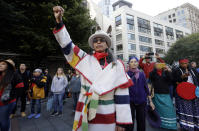<p>Art Cedar, of the Aluet and Blackfeet tribes, raises a fist as he listens to performers drum and sing during an Indigenous Peoples Day event Monday, Oct. 9, 2017, in Seattle. (Photo: Elaine Thompson/AP) </p>